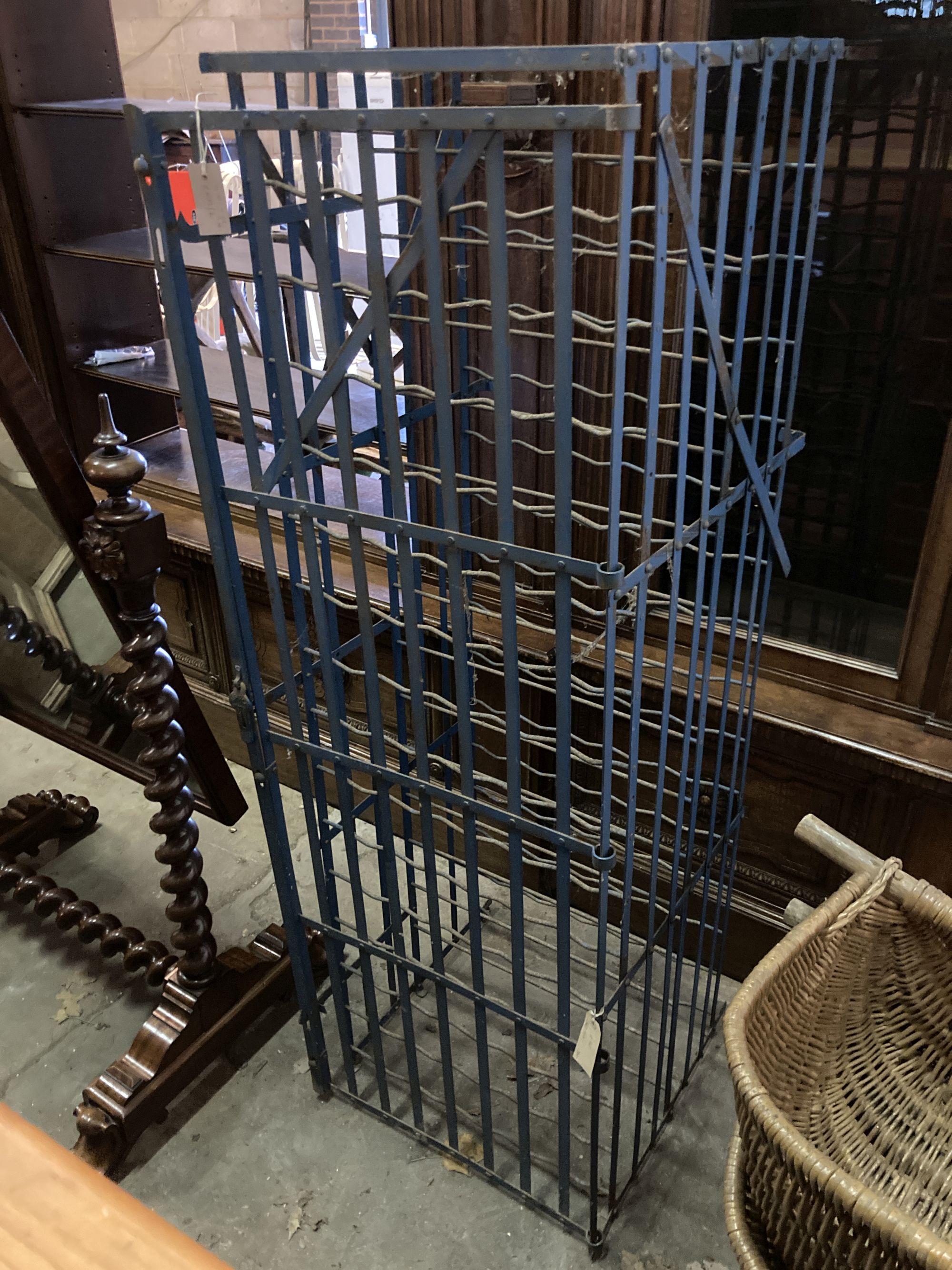 A French blue painted wrought iron wine rack cage, length 56cm, depth 58cm, height 166cm